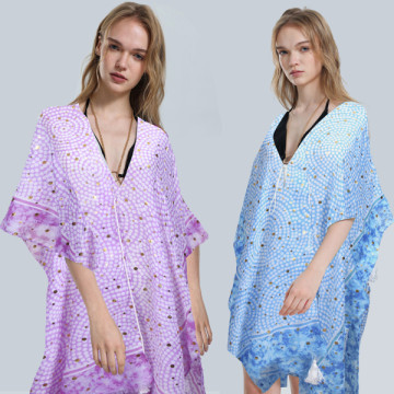 100% Polyester poncho, with gold decorations. Open with drawstring finished in pom pom One size - 2 colors